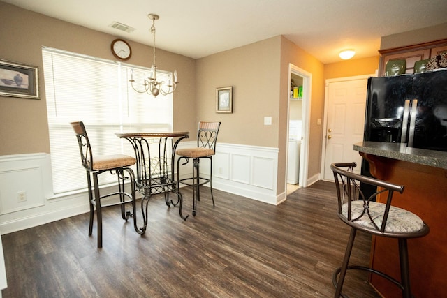 3107 Camden Way, Graniteville, SC 29829 - dining space featuring dark wood finished floors, a wainscoted wall, a chandelier, and a decorative wall