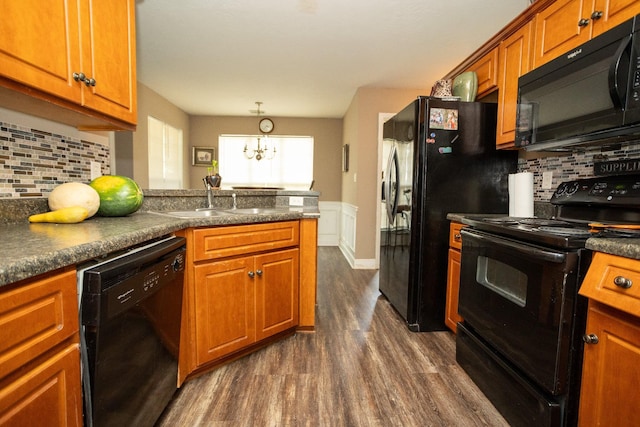 3107 Camden Way, Graniteville, SC 29829 - kitchen featuring black appliances, dark wood-style floors, brown cabinetry, a chandelier, and dark countertops