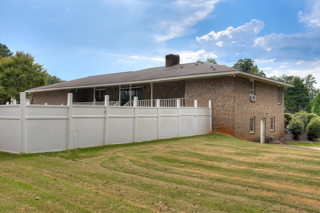 back of house featuring a yard