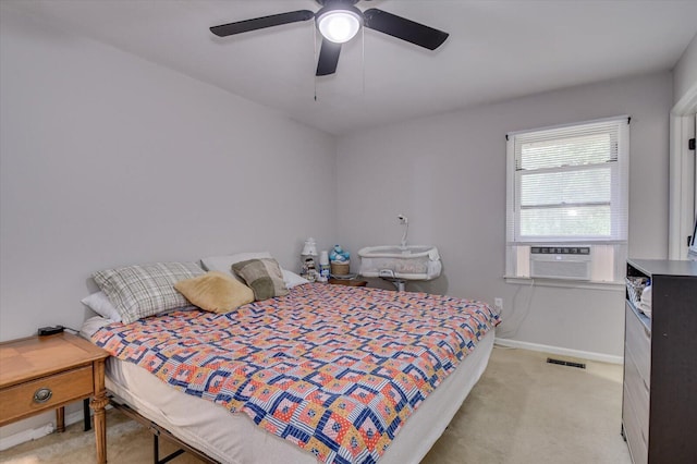 carpeted bedroom with ceiling fan and cooling unit