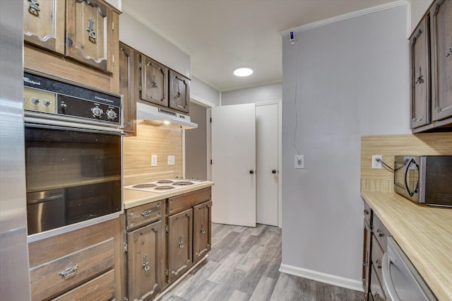 kitchen with white appliances and light hardwood / wood-style floors