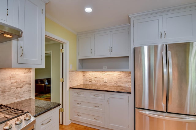 802 Dunbarton Dr, North Augusta, SC 29841 - kitchen with freestanding refrigerator, backsplash, dark stone countertops, ornamental molding, and white cabinets