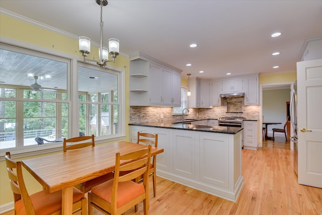 802 Dunbarton Dr, North Augusta, SC 29841 - kitchen featuring open shelves, a peninsula, backsplash, hanging light fixtures, and light wood-style flooring