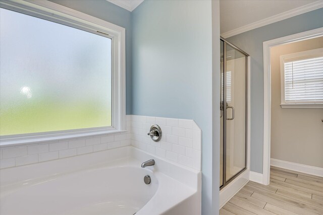 5816 Whispering Pines Way, Evans, GA 30809 - bathroom featuring ornamental molding, a garden tub, a shower stall, healthy amount of natural light, and wood finished floors