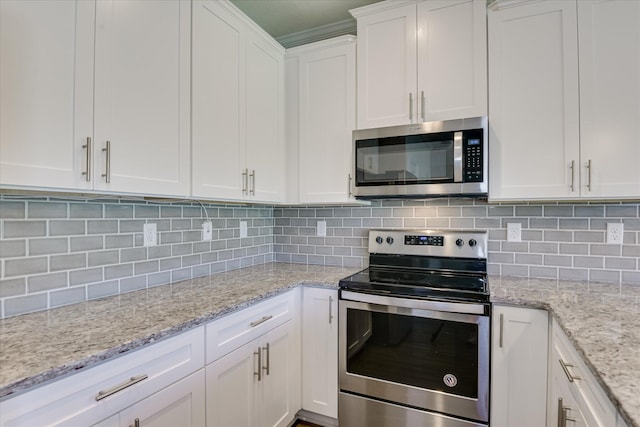 5816 Whispering Pines Way, Evans, GA 30809 - kitchen with appliances with stainless steel finishes, white cabinetry, decorative backsplash, and light stone countertops