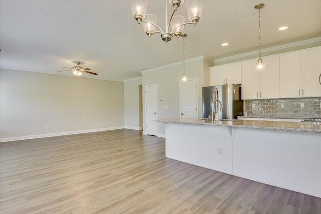 5816 Whispering Pines Way, Evans, GA 30809 - kitchen featuring freestanding refrigerator, crown molding, ceiling fan, white cabinetry, and backsplash