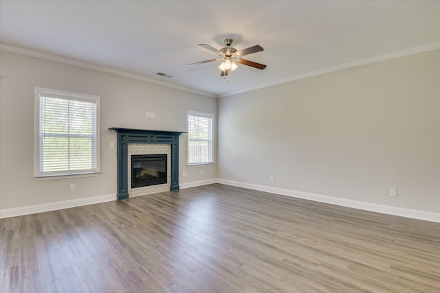 5816 Whispering Pines Way, Evans, GA 30809 - unfurnished living room featuring wood finished floors, a ceiling fan, a tiled fireplace, baseboards, and ornamental molding
