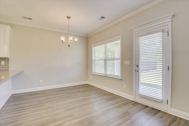 5816 Whispering Pines Way, Evans, GA 30809 - unfurnished dining area with light wood finished floors, crown molding, a chandelier, and baseboards