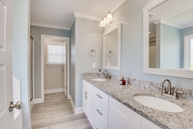 5816 Whispering Pines Way, Evans, GA 30809 - full bath with wood finished floors, double vanity, baseboards, a shower stall, and ornamental molding