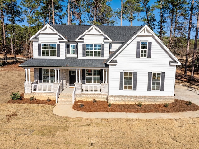 view of front facade with covered porch and a front lawn