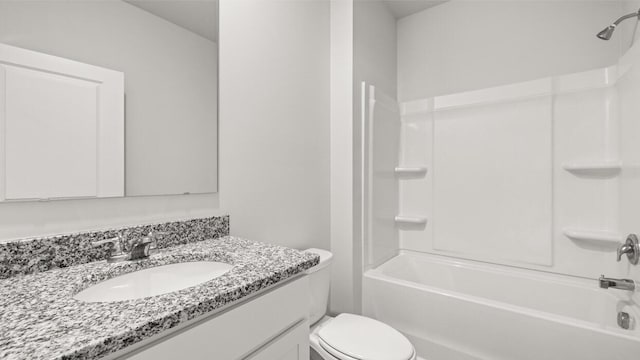 bathroom with shower / washtub combination, toilet, and vanity