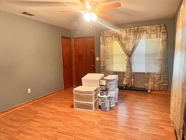 interior space featuring wood-type flooring and ceiling fan