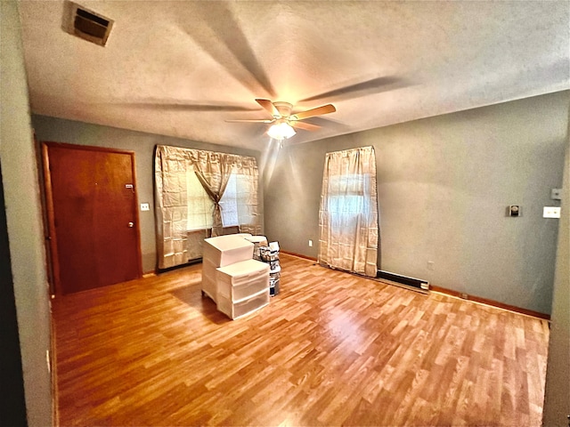 unfurnished bedroom with light hardwood / wood-style flooring and a textured ceiling