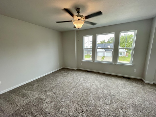 carpeted empty room featuring ceiling fan