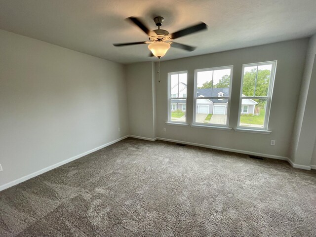 carpeted empty room featuring ceiling fan