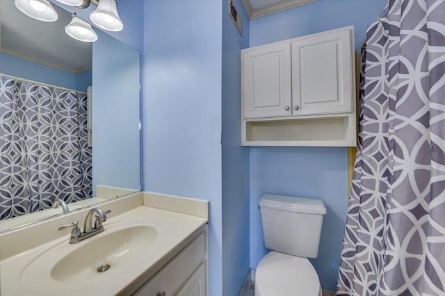 full bath featuring vanity, visible vents, crown molding, and toilet