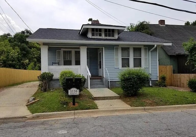1110 Roselle St, Augusta, GA 30901 - bungalow-style home with a porch, fence, a chimney, and roof with shingles