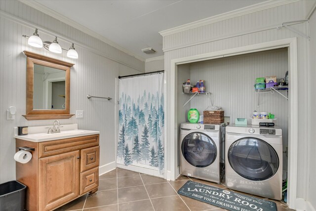 710 River View Dr, North Augusta, SC 29841 - washroom featuring crown molding, laundry area, dark tile patterned floors, washing machine and clothes dryer, and a sink