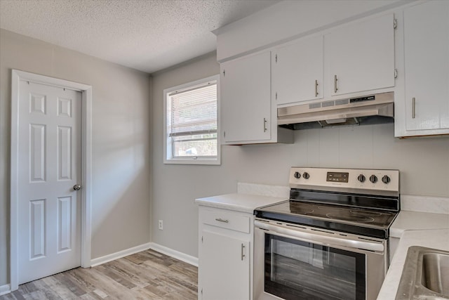 605 Kershaw Dr, North Augusta, SC 29841 - kitchen featuring stainless steel range with electric cooktop, under cabinet range hood, light countertops, light wood-style flooring, and a textured ceiling