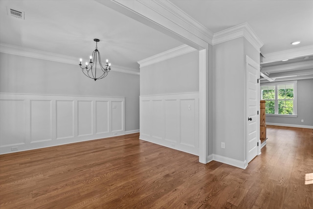 831 Whitney Shoals Rd, Evans, GA 30809 - unfurnished dining area with a decorative wall, crown molding, a chandelier, wood finished floors, and a wainscoted wall