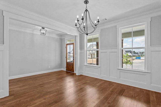 831 Whitney Shoals Rd, Evans, GA 30809 - unfurnished room featuring a chandelier, a decorative wall, wood finished floors, and crown molding