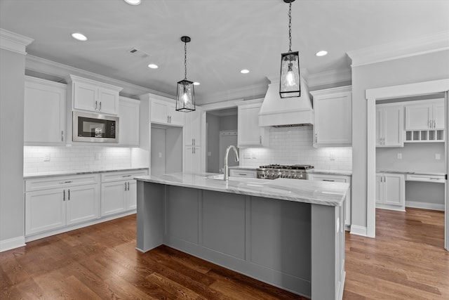 831 Whitney Shoals Rd, Evans, GA 30809 - kitchen featuring built in microwave, white cabinetry, tasteful backsplash, crown molding, and recessed lighting