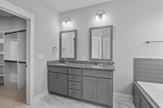 831 Whitney Shoals Rd, Evans, GA 30809 - bathroom featuring marble look tiles, double vanity, and a tub to relax in