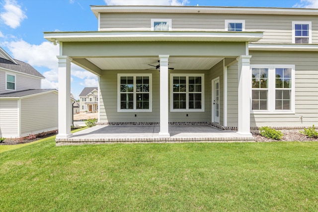 831 Whitney Shoals Rd, Evans, GA 30809 - rear view of house featuring a ceiling fan, a lawn, and a patio area