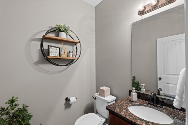 bathroom featuring toilet and vanity