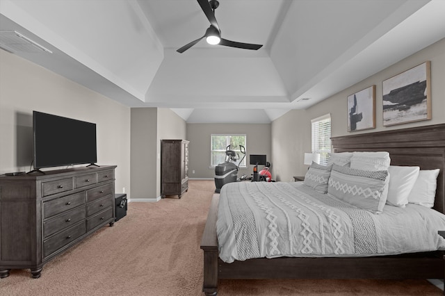 bedroom with light colored carpet, a tray ceiling, baseboards, and a ceiling fan
