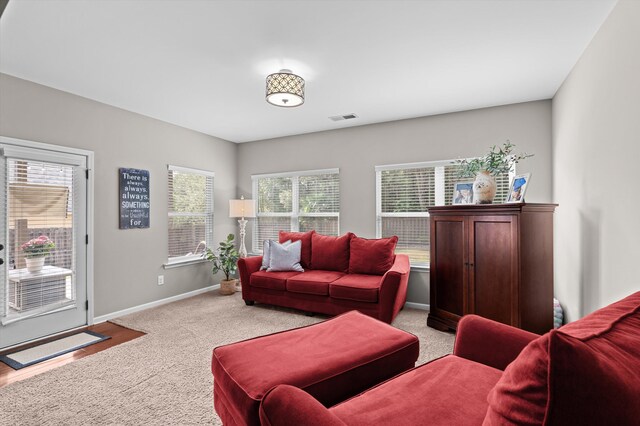 carpeted living room with baseboards