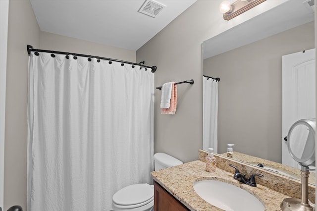 bathroom with toilet and vanity