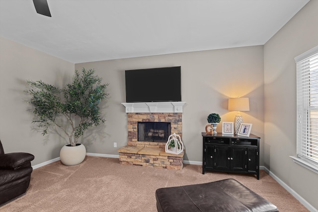 living area with carpet, healthy amount of natural light, and a fireplace