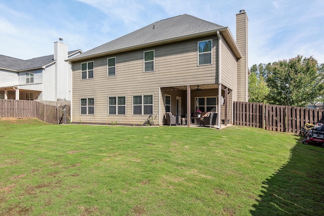 rear view of house with a chimney and a patio area