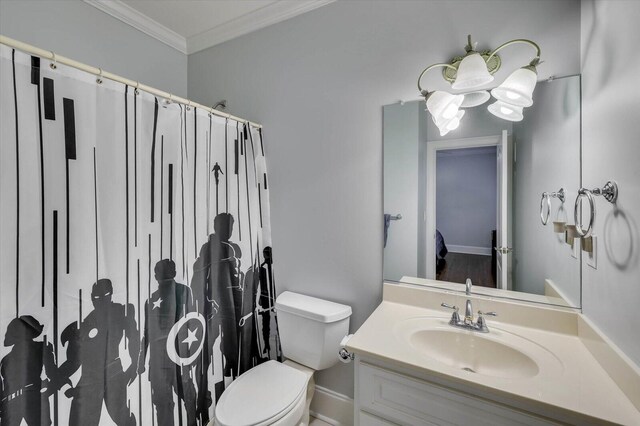 bathroom with vanity, toilet, and crown molding