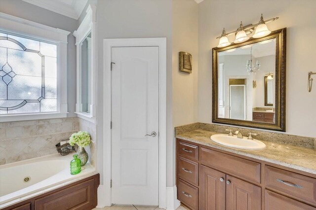 bathroom featuring plus walk in shower, tile patterned floors, crown molding, a chandelier, and vanity