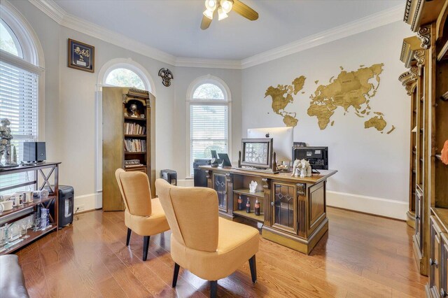 office area with ceiling fan, crown molding, and light wood-type flooring