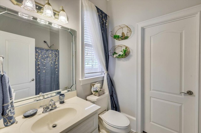 bathroom featuring vanity and toilet