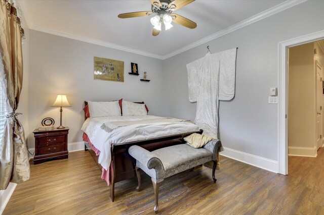 bedroom with hardwood / wood-style flooring, ceiling fan, and crown molding