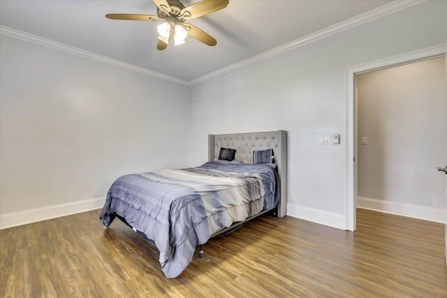 bedroom featuring hardwood / wood-style floors, ceiling fan, and crown molding