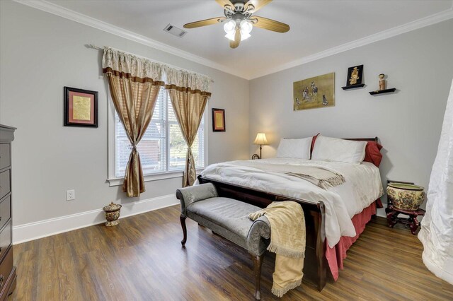 bedroom with dark hardwood / wood-style floors, ceiling fan, and crown molding