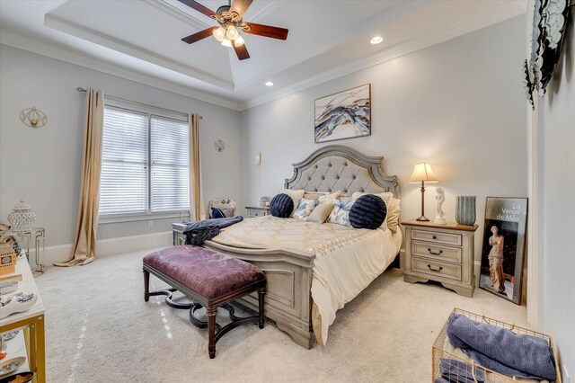 carpeted bedroom featuring a raised ceiling, ceiling fan, and crown molding