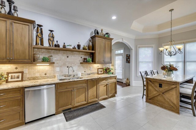 kitchen featuring decorative backsplash, a breakfast bar, a raised ceiling, sink, and dishwasher