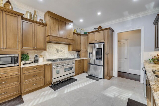 kitchen with light stone countertops, tasteful backsplash, ornamental molding, stainless steel appliances, and light tile patterned floors