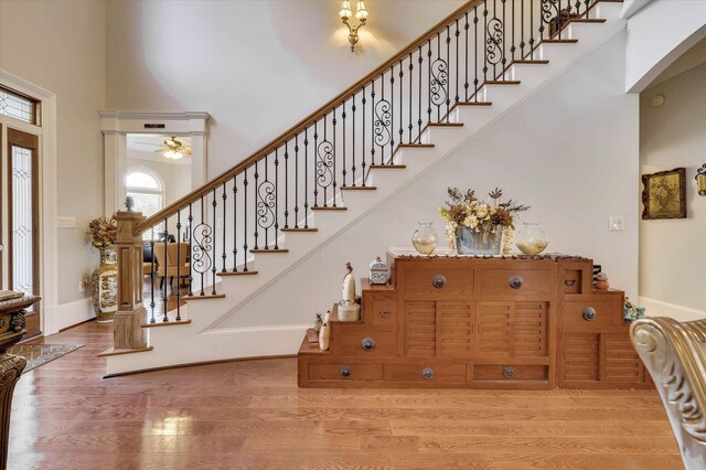 entryway featuring hardwood / wood-style flooring and a towering ceiling