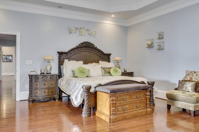 bedroom featuring crown molding and hardwood / wood-style floors