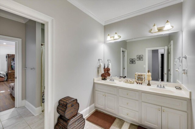 bathroom with tile patterned flooring, vanity, and crown molding