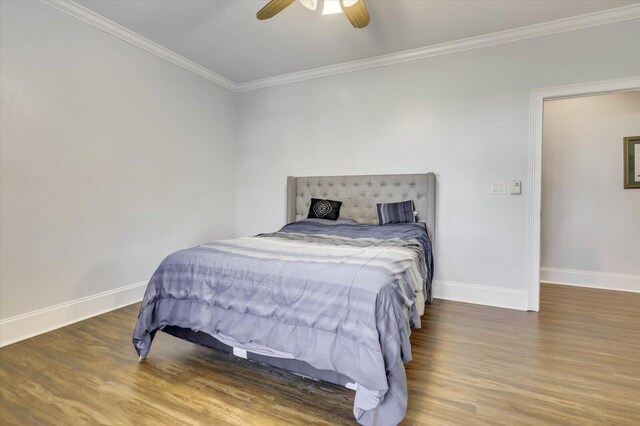 bedroom with ceiling fan, dark hardwood / wood-style flooring, and crown molding