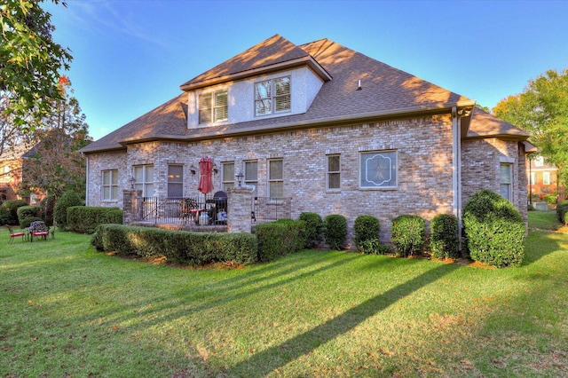 rear view of house with a patio area and a yard