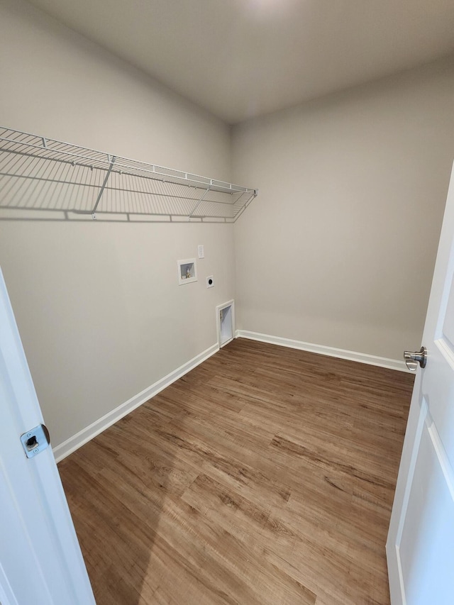 laundry area with wood-type flooring, hookup for a washing machine, and electric dryer hookup